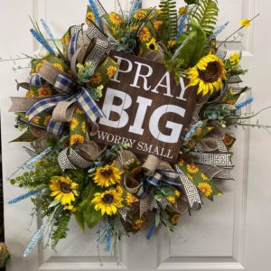 sunflower wreath with a wooden sign that says pray big
