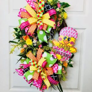 grapevine wreath with easter chick sign and pink and yellow bow