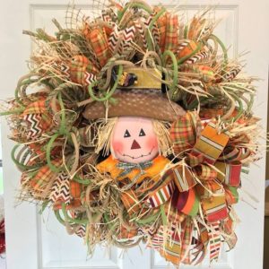 fall themed wreath with a cute scarecrow head