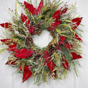 grapevine wreath with poinsettia leaves, pinecones, and greenery