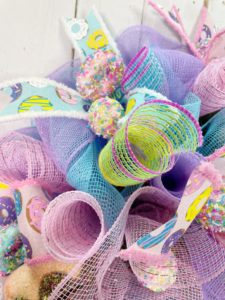 close up of pastel pink, blue, and purple deco mesh and easter themed ribbon