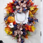 Wreath with fall leaves and a sign