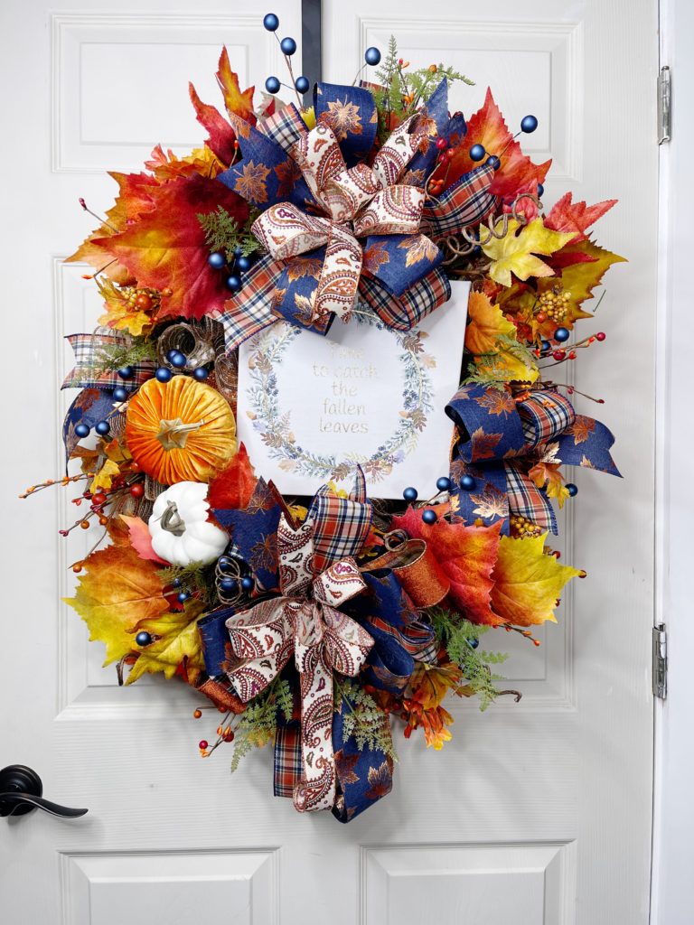 Wreath with fall leaves and a sign