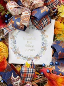 Wreath with fall leaves and a sign