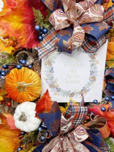 Wreath with fall leaves and a sign