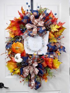 Wreath with fall leaves and a sign