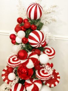 small fake christmas tree with decorative peppermint candy