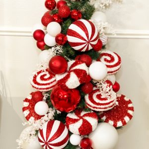 small fake christmas tree with decorative peppermint candy