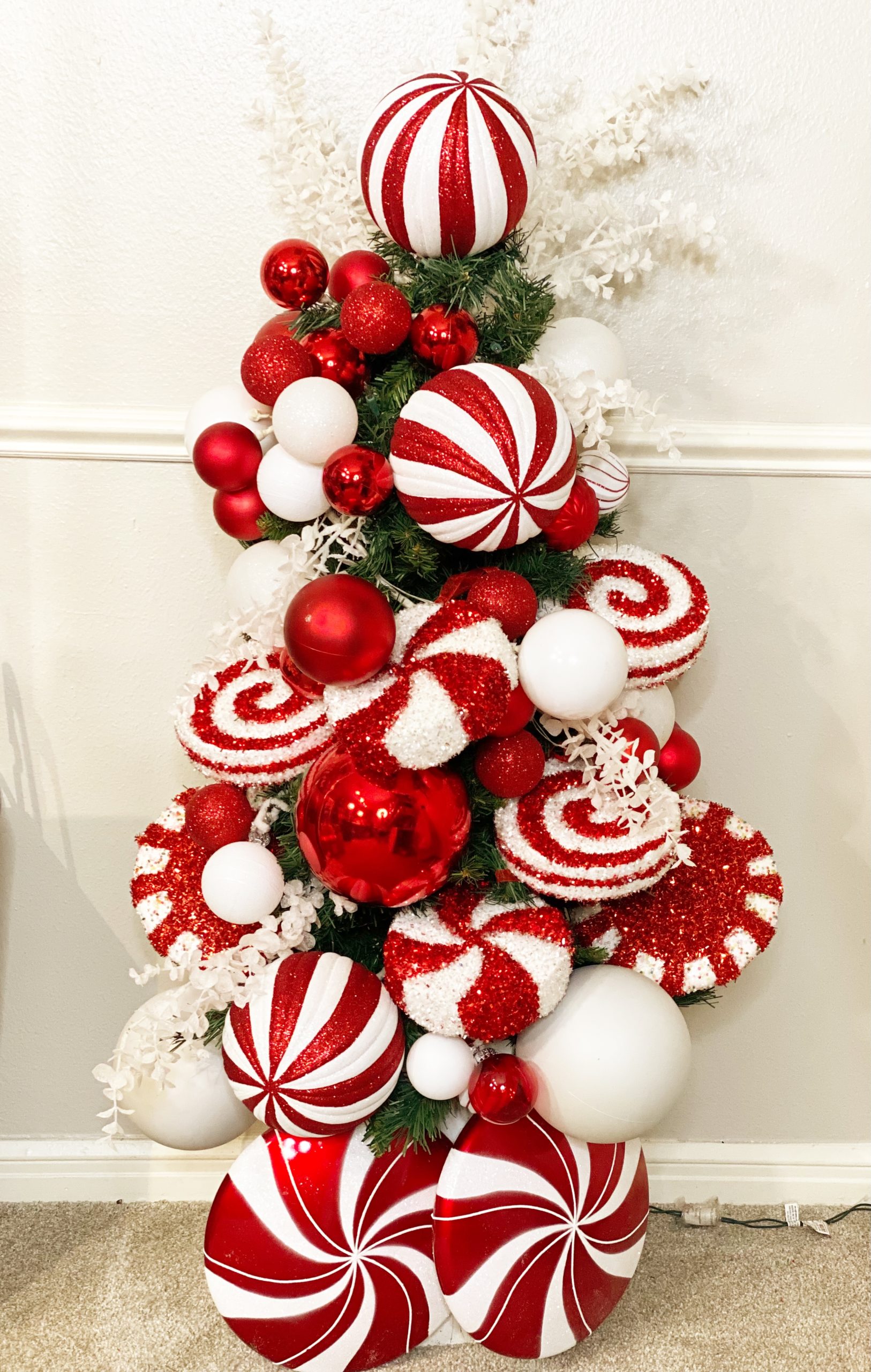 small fake christmas tree with decorative peppermint candy