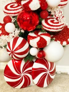small fake christmas tree with decorative peppermint candy
