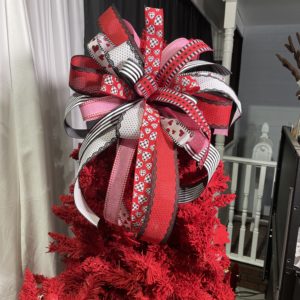 red christmas tree with large bow on top