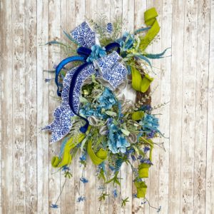grapevine with greenery and blue florals and ribbon