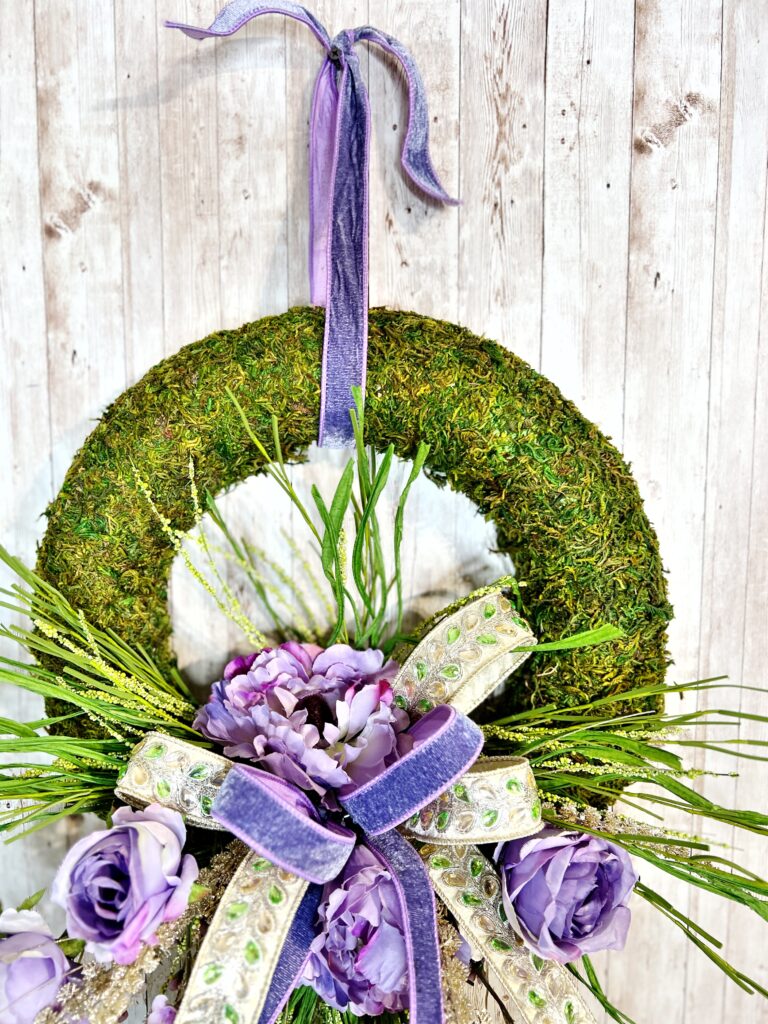 moss foam wreath with purple florals