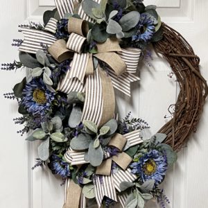 grapevine wreath with periwinkle sunflowers and greenery